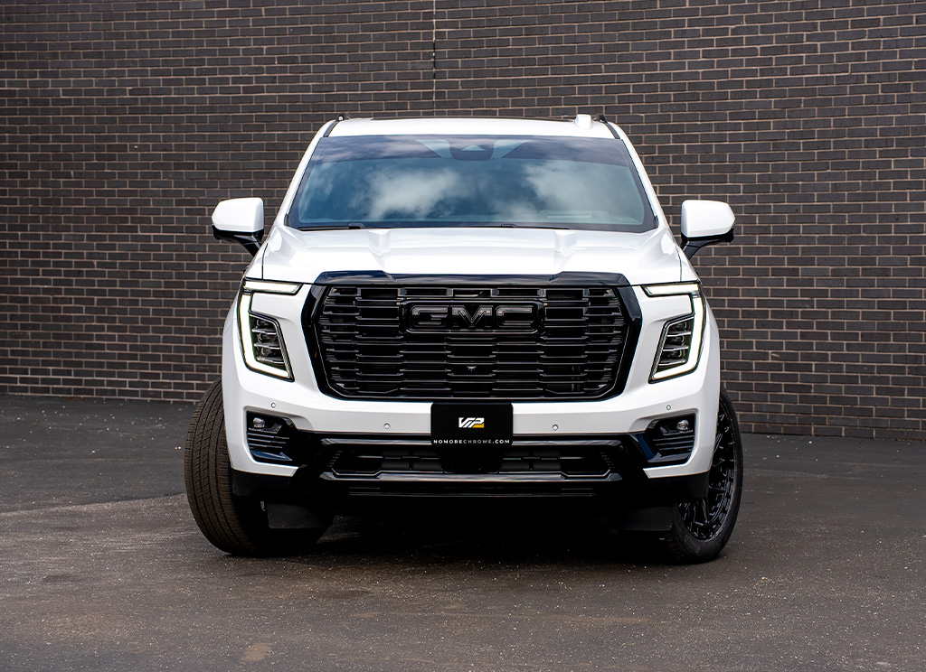 White 2026 GMC Yukon Denali with blackout grille, bumpers, and black GMC emblem.