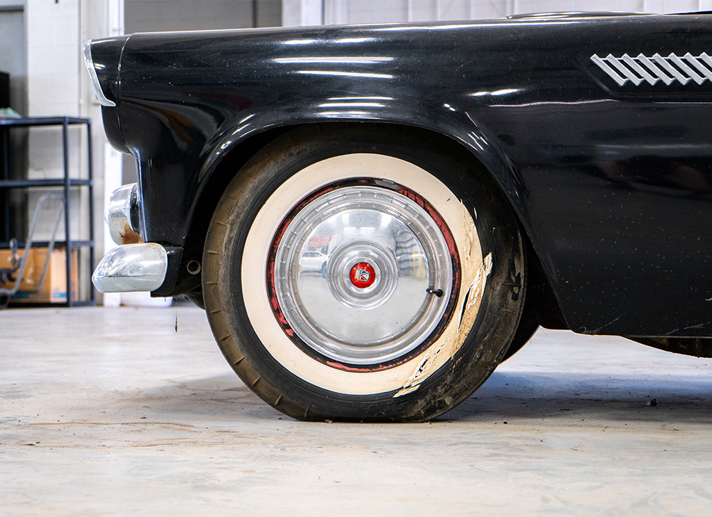 Original wheels on an old 1956 Ford Thunderbird prior to restoration.