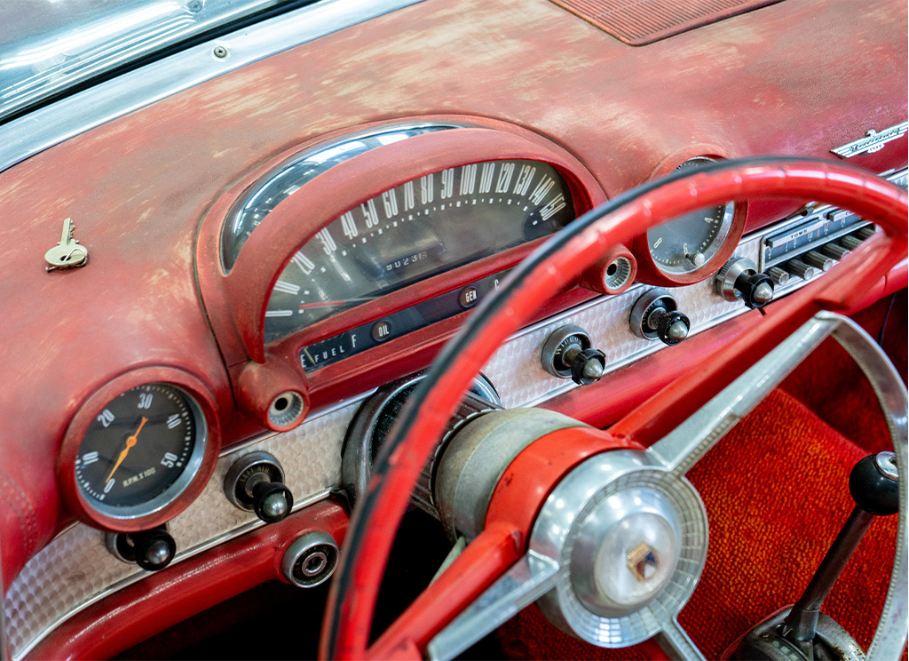 Weathered old red dashboard on a 1956 Ford Thunderbird.