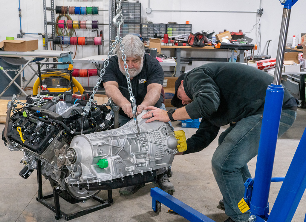 Technicians installing a new 10-speed automatic transmission.