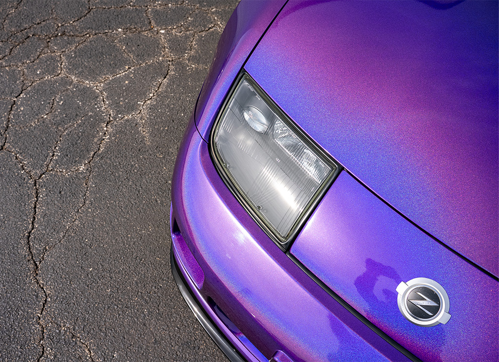 Close-up of a iridescent purple color flip wrap on the hood of a Nissan 300ZX.