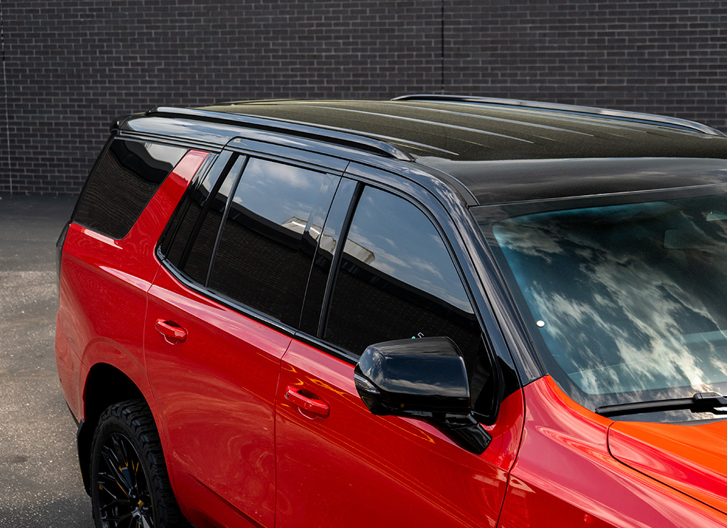 Black roof rap and black roof rails on a red 2026 Chevy Tahoe.