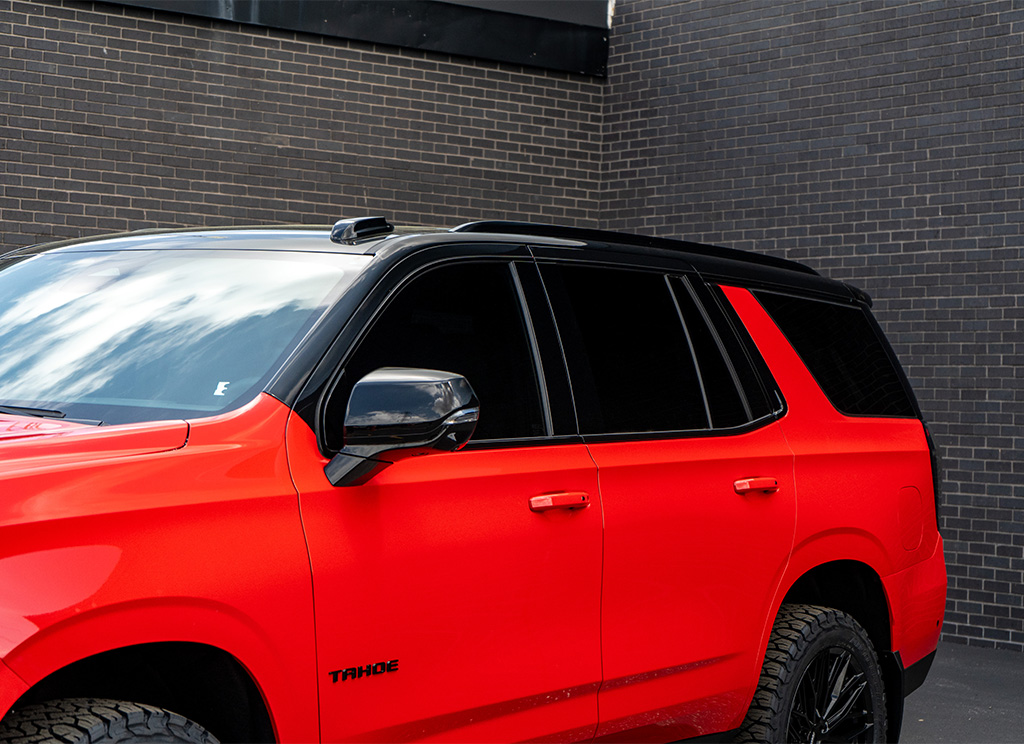 Close-up of 20% window tint on a custom Victory Red 2026 chevy Tahoe.