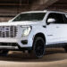 Custom 2026 GMC Yukon Denali Ice White Color-matched grille and blackout chrome delete trim.