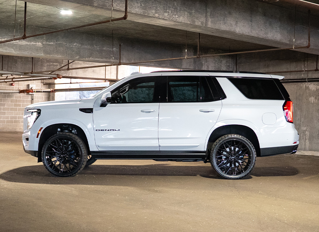 Side profile of a custom White Frost 2026 GMC Yukon Denali chrome delete.