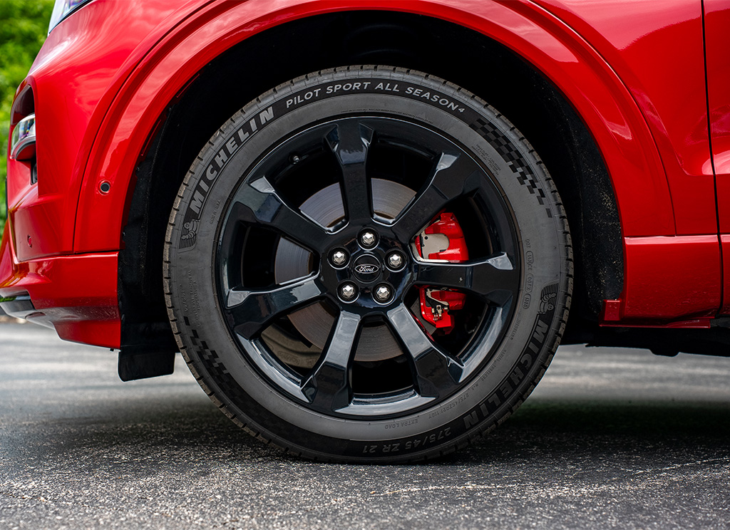 Close-up of black 2022 Ford Explorer factory wheels and red painted calipers.
